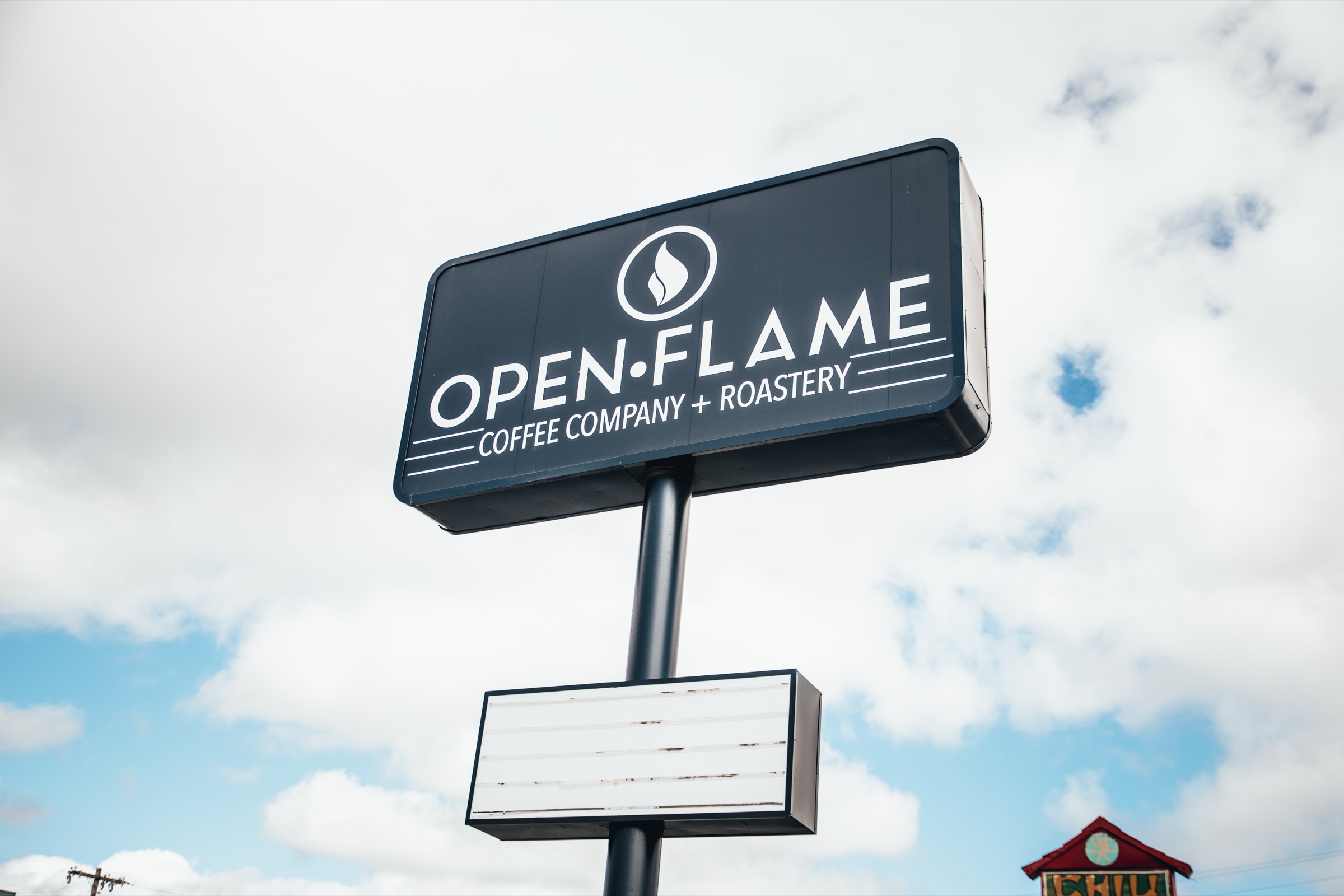 OpenFlame Coffee Company and Roastery roadside sign in Midwest City
